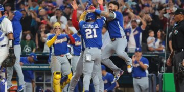 Ronald Acuña Jr. (21) and Gleyber Torres (25) react after Acuña scores in a World Baseball Classic semifinal game.