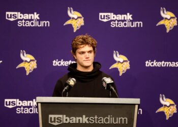 Minnesota Vikings quarterback J.J. McCarthy speaking at a news conference.