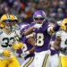 Minnesota Vikings wide receiver Justin Jefferson (18) celebrates in front of Green Bay Packers safety Evan Williams (33) after catching a pass.