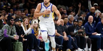 Stephen Curry of the Golden State Warriors reacts after scoring during the second half of a game.