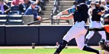 New York Yankees designated hitter Giancarlo Stanton drives in a run with a sacrifice fly ball against the Baltimore Orioles.
