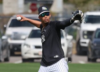 New York Yankees third baseman Oswaldo Cabrera throwing a ball during practice.