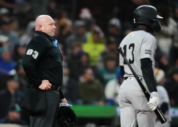 Mike Estabrook (83) reacts as New York Yankees' Jazz Chisholm Jr. challenges a call during the fourth inning of a baseball game against the Seattle Mariners, Monday, March 30, 2026, in Seattle.