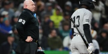Mike Estabrook (83) reacts as New York Yankees' Jazz Chisholm Jr. challenges a call during the fourth inning of a baseball game against the Seattle Mariners, Monday, March 30, 2026, in Seattle.