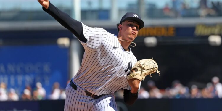 New York Yankees pitcher Carlos Lagrange #84, throwing a warmup pitch before the start of the 2nd inning.