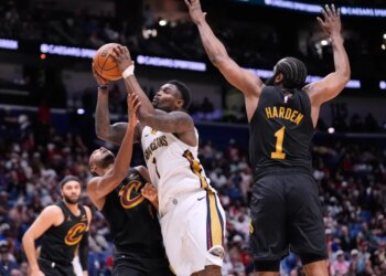 Zion Williamson (1) drives to the basket against Cleveland Cavaliers center Evan Mobley (4) and guard James Harden (1) in the second half of an NBA basketball game, Saturday, March 21, 2026, in New Orleans.