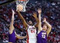 St. John's Red Storm forward Zuby Ejiofor #24 shooting a basketball over Northern Iowa Panthers players Ben Schwieger #7 and Will Hornseth #13 at the NCAA Tournament.
