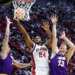 St. John's Red Storm forward Zuby Ejiofor #24 shooting a basketball over Northern Iowa Panthers players Ben Schwieger #7 and Will Hornseth #13 at the NCAA Tournament.