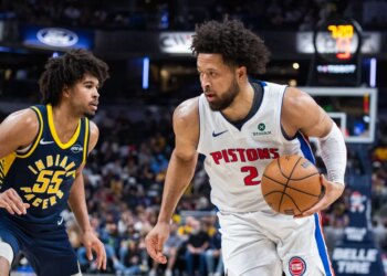 Detroit Pistons guard Cade Cunningham dribbles the ball while Indiana Pacers guard Ethan Thompson defends.