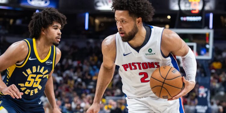 Detroit Pistons guard Cade Cunningham dribbles the ball while Indiana Pacers guard Ethan Thompson defends.