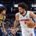 Detroit Pistons guard Cade Cunningham dribbles the ball while Indiana Pacers guard Ethan Thompson defends.