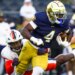 Notre Dame running back Jeremiyah Love getting past Virginia linebacker Kam Robinson during an NCAA college football game.