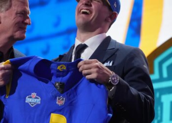 Ty Simpson in a Rams hat, holding a Rams jersey with Roger Goodell.