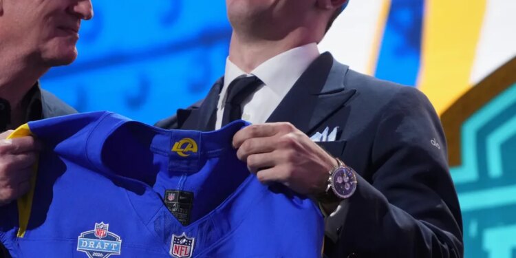 Ty Simpson in a Rams hat, holding a Rams jersey with Roger Goodell.