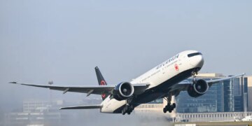 An Air Canada Boeing 777 passenger jet taking off from Brussels Airport.