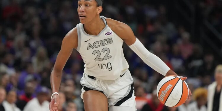 Las Vegas Aces center A'ja Wilson (22) dribbles against the Phoenix Mercury during the first half of Game 4 of the WNBA basketball finals, Friday, Oct. 10, 2025, in Phoenix.