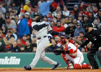 New York Yankees third baseman Amed Rosario hitting a three-run home run.