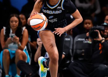 A Chicago Sky basketball player dribbles the ball down the court during a game.