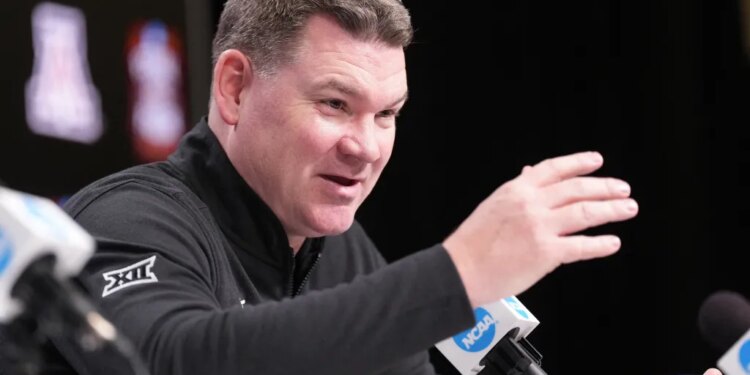 Arizona head coach Tommy Lloyd talks to the media at Lucas Oil Stadium on April 2, 2026 in Indianapolis.