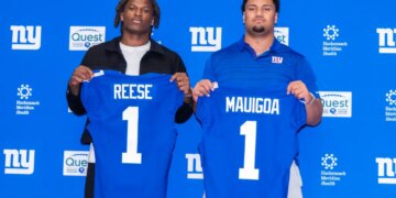 New York Giants draft picks Arvell Reese and Francis Mauigoa holding up their blue jerseys with their last names and the number 1.