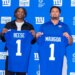 New York Giants draft picks Arvell Reese and Francis Mauigoa holding up their blue jerseys with their last names and the number 1.