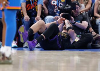 Luka Doncic lying on the court after falling during a play.