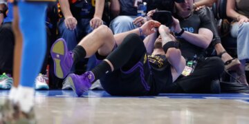 Luka Doncic lying on the court after falling during a play.