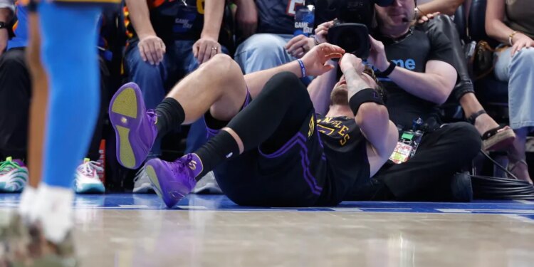 Luka Doncic lying on the court after falling during a play.