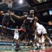 Miami Heat's Dwyane Wade reacting as teammate LeBron James goes up for a dunk against the Milwaukee Bucks.