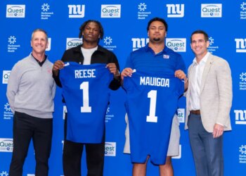 New York Giants draft picks Francis Mauigoa and Arvell Reese hold up their jerseys with Head Coach John Harbaugh and General Manager Joe Schoen.