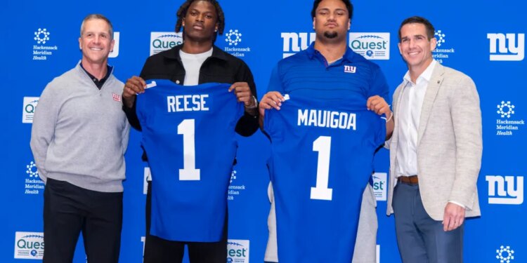 New York Giants draft picks Francis Mauigoa and Arvell Reese hold up their jerseys with Head Coach John Harbaugh and General Manager Joe Schoen.
