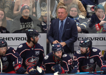 Columbus Blue Jackets coach Rick Bowness, center top, looks on during the third period of an NHL hockey game against the Winnipeg Jets in Columbus, Ohio, Saturday, April 4, 2026.