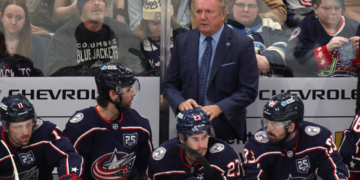 Columbus Blue Jackets coach Rick Bowness, center top, looks on during the third period of an NHL hockey game against the Winnipeg Jets in Columbus, Ohio, Saturday, April 4, 2026.