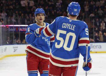 New York Rangers left wing Will Cuylle (50) is greeted by New York Rangers defenseman Braden Schneider (4) after he scores a goal