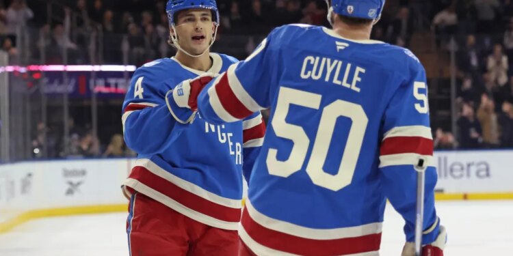 New York Rangers left wing Will Cuylle (50) is greeted by New York Rangers defenseman Braden Schneider (4) after he scores a goal