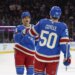 New York Rangers left wing Will Cuylle (50) is greeted by New York Rangers defenseman Braden Schneider (4) after he scores a goal