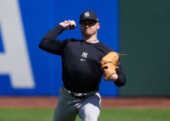New York Yankees pitcher Cade Winquest warming up for a baseball game.
