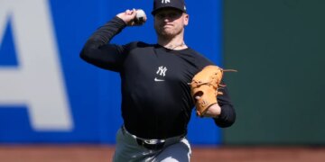 New York Yankees pitcher Cade Winquest warming up for a baseball game.