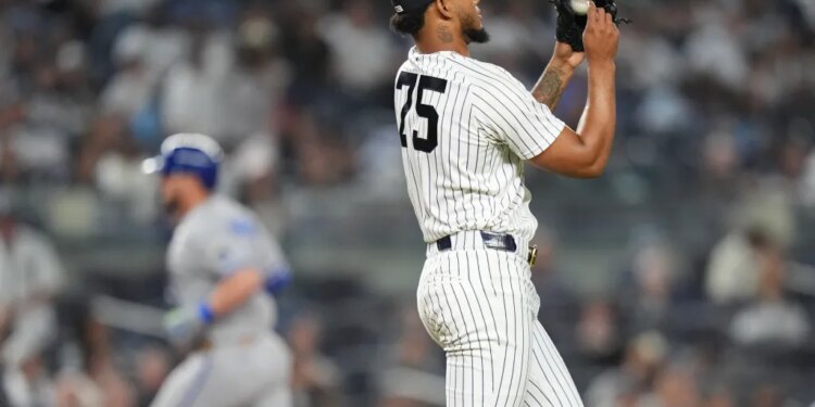 New York Yankees pitcher Camilo Doval (75) reacts as Kansas City Royals' Vinnie Pasquantino runs the bases after hitting a home run during the eighth inning of a baseball game Friday, April 17, 2026, in New York.