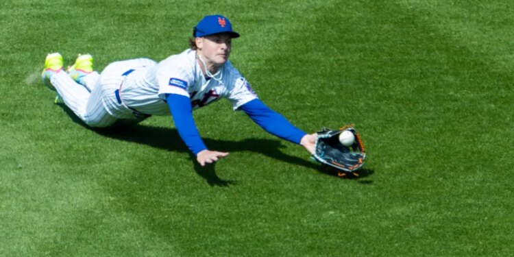 New York Mets outfielder Carson Benge diving to catch a fly ball.