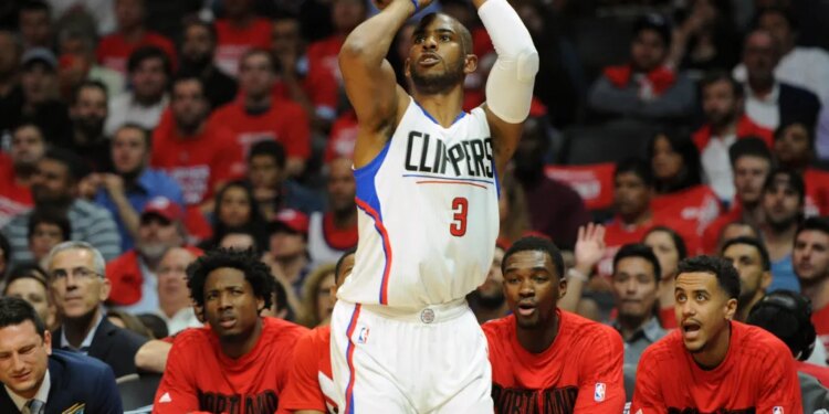 Los Angeles Clippers guard Chris Paul shooting a three-point basket during a basketball game.