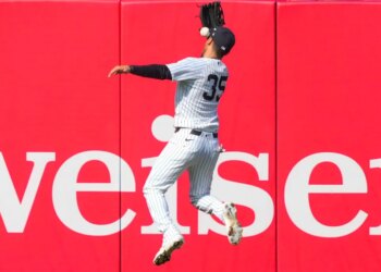 New York Yankees left fielder Cody Bellinger (35) catches a fly ball by Miami Marlins' Xavier Edwards (9) during the ninth inning of a home-opener baseball game, Friday, April 3, 2026, in New York.