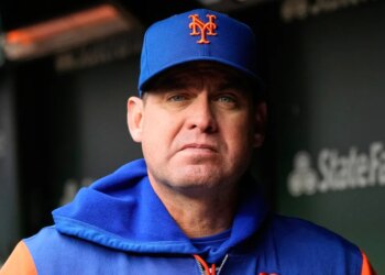 Carlos Mendoza, manager of the New York Mets, looks forward in his dugout.