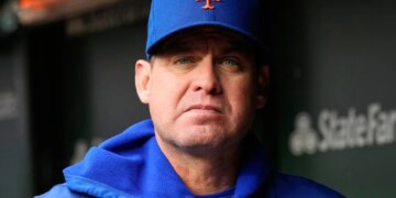 Carlos Mendoza, manager of the New York Mets, looks forward in his dugout.