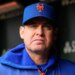 Carlos Mendoza, manager of the New York Mets, looks forward in his dugout.