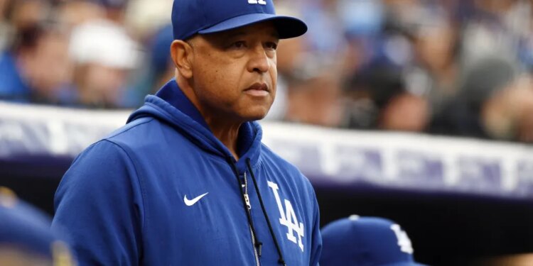 Los Angeles Dodgers manager Dave Roberts watching from the dugout during a baseball game.