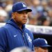 Los Angeles Dodgers manager Dave Roberts watching from the dugout during a baseball game.