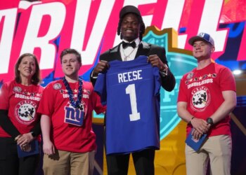 Ohio State linebacker Arvell Reese poses with a New York Giants jersey after being chosen during the NFL football draft.