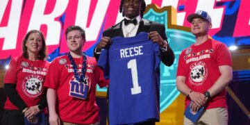 Ohio State linebacker Arvell Reese poses with a New York Giants jersey after being chosen during the NFL football draft.
