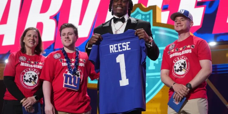 Ohio State linebacker Arvell Reese poses with a New York Giants jersey after being chosen during the NFL football draft.